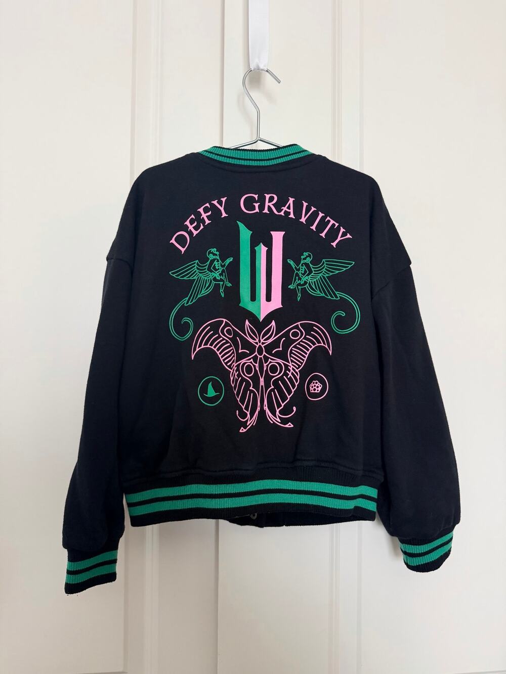 Wicked Girls’ Defy Gravity Varsity Jacket black green pink Paul Tazewell